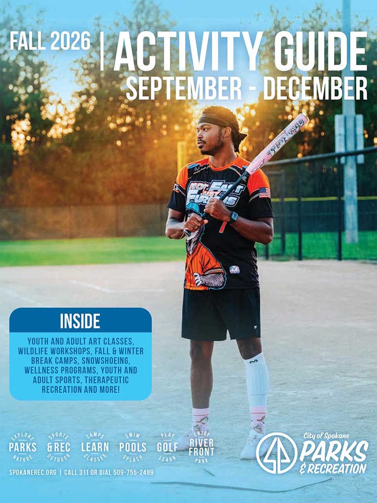 front of activity guide showing man in sports jersey standing on the field holding baseball bat. 